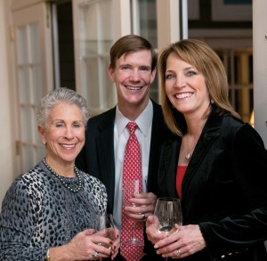 Party hostess Kit Slaugh with event emcee Lori Burkholder and husband Jeff Goss. “It is interesting to think of 100 years from now and know that you were important in the life of a child,” notes Lori, for whom serving as event emcee has brought her close to the mission and cause. Lori reflects that “any one of us could be in need” and by helping Milagro House, “there is a ‘domino effect’… one person helping another person, which is why I find it so compelling. It’s the right thing to do.”