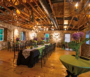 The second floor serves as the venue’s ballroom. Artwork consists of implements that are original to the mill. Note the tin chandeliers crafted by Charles Messner. Claudia Himes of Special Occasions & Queen Street Linens is the exclusive linens supplier for Bear Mill. Rettew’s Catering is the preferred caterer for the venue. Note Kerry’s early-fall floral designs.