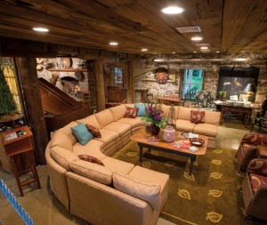 Kerry implemented his idea to transform the mill’s first floor (half of which was once a garage) into a welcoming gathering place. The ceiling is lined with reclaimed pecky cypress. Two of the three posts are original to the space (Ben Graybill created the look-alike replacement). Kerry’s ploy obviously worked. Visitors to his home tend to end up at the mill. Note the reproduction Indian door and the original fireplace.