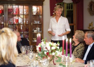 Program Administrator Bethany Woodcock shares information about the projects she is involved with at the Mission with dinner guests.