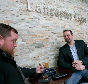 Friends James Diener (left) and Mike Cardina like the fact that Lancaster Cigar Bar provides a setting in which they can smoke cigars, enjoy a beer or cocktail and sample the tapas-inspired menu.  