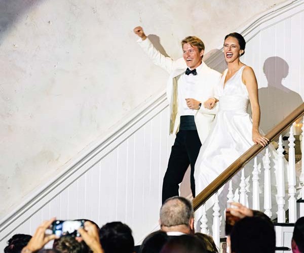 The newlyweds make a grand entrance at their reception, which was held at Excelsior.