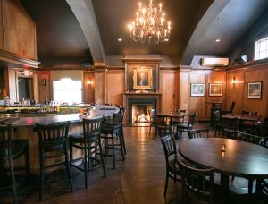 The Tavern Room features a U-shaped bar and seating at various style tables. 
