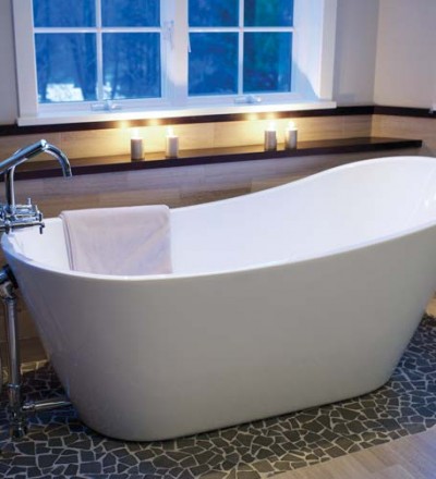 The soaking tub rests upon a stone rug. The design is repeated on the floor of the shower.