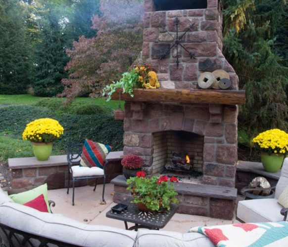 A concrete pad expanded the deck and provides a sitting area whose focal point is the fireplace that Dwight designed using sandstone from razed farm buildings.