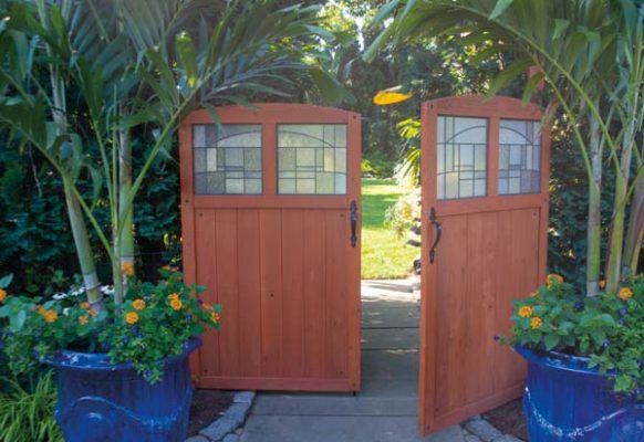 Tim and James spied these doors at Lowe’s and thought they would provide the perfect entrance to the backyard gardens. They’re flanked by Tim’s signature container gardens.