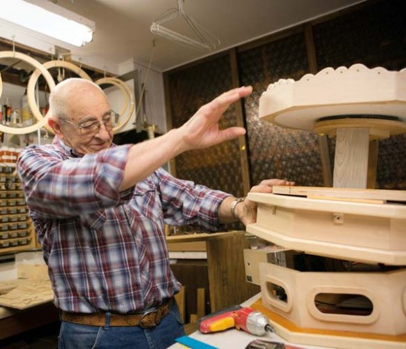 Larry at work on a carousel in his basement workshop.