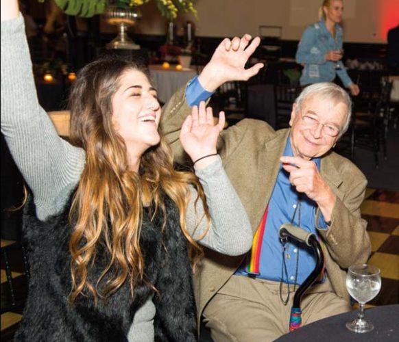Sydney and her grandfather, Bob Groff, groove to the music.