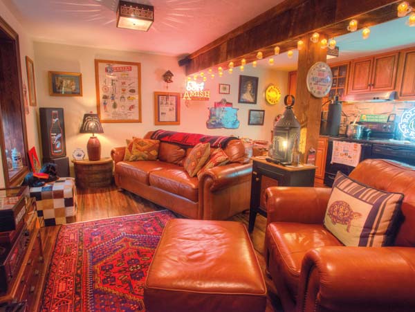 What had been a storage room filled with dead computers and empty boxes was remodeled into a beer kitchen where Kurt takes on the role of “mad scientist” and makes beer to his heart’s content. He credits the look of the space to Dwight Graybill (Cocalico Builders), who purchased the cabinetry at an auction, relocated the beams from a barn on the property and salvaged the teak/mahogany flooring from tractor-trailer trucks. Kurt’s wife, Tracy, also gets kudos for finding the specialty lighting on the beam, as well as much of the “beer art” that hangs on the walls. Family memorabilia also decorates the space.